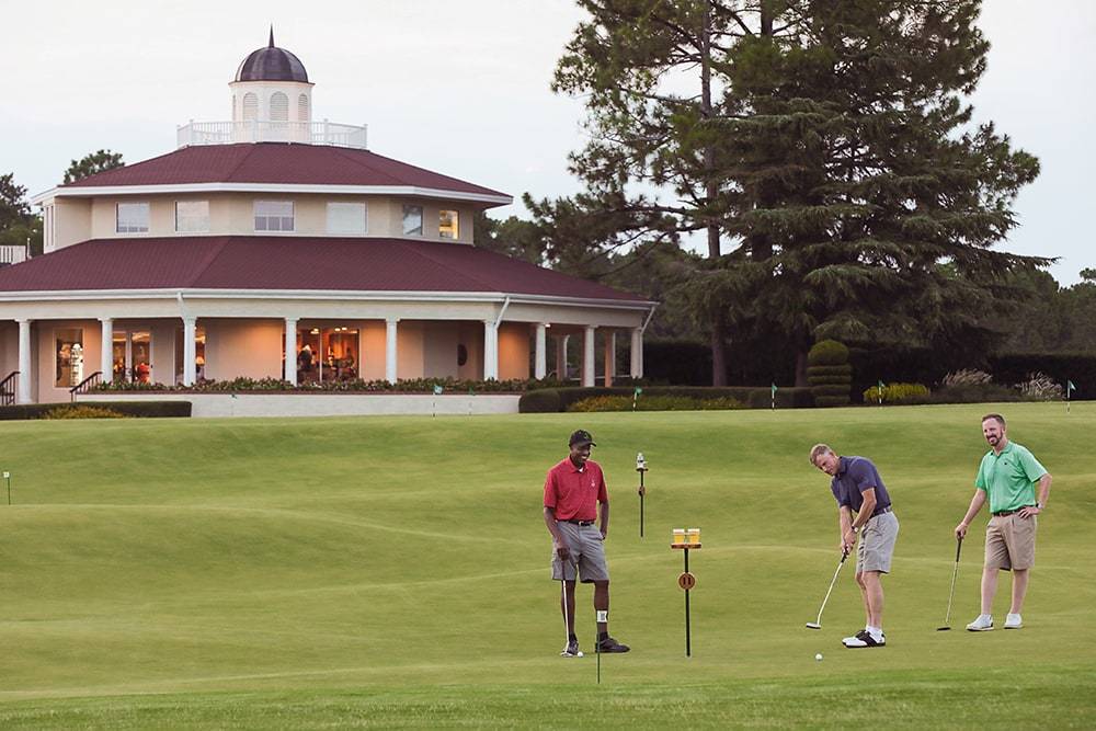 Golfers putting